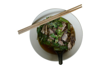 Duck noodle with wooden chobsticks in white bowl, isolated on white, top view