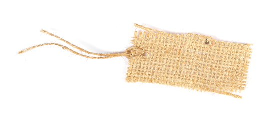Blank textile, jute, linen tied tag isolated on white background