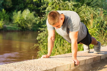 Man doing push ups by the river