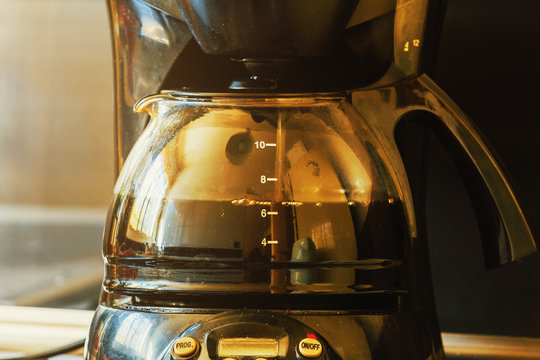 Close-up of electric glass coffee pot with measurer