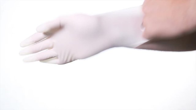 Doctor puts on glove isolated 