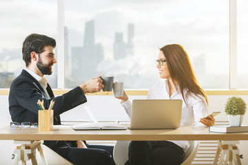 Attractive man and woman drinking coffee