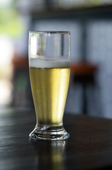Glass of beer on a table of popular bar