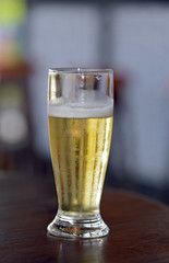 Glass of beer on a table of popular bar