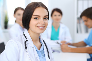 Fototapeta premium Female doctor leading a medical team at the hospital