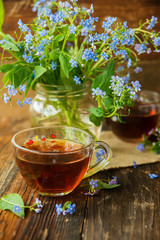 Two cups of tea and summer flowers