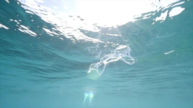 Plastic floats in ocean, close up
