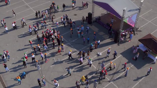 Flycam Rotates above Stage Gathered People to Take Part in Event