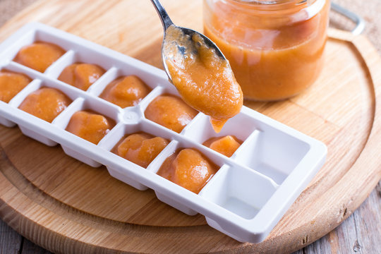 Baby food homemade in ice cubes tray ready to be frozen