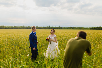 Photographer taking pictures couple of newlyweds