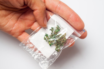 A packet with a dose of medicinal hemp according to the doctor's prescription for the treatment of nerves in the hands of a person