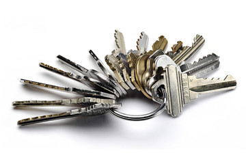 Close up of metal key ring with many worn keys isolated on white