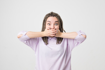 portrait of young woman shocked, isolated on a gray background