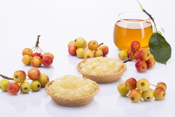 Still life. Two cakes with apple jam, bunches of small apples and apple juice.