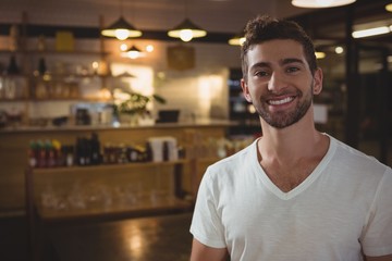 Naklejka premium Portrait of smiling waiter in cafe