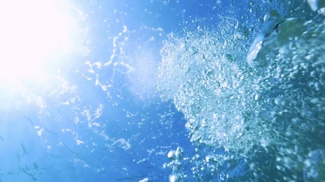 Bubbles float to ocean surface, low angle
