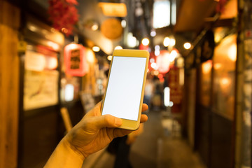 a man using smart phone in nightlife district