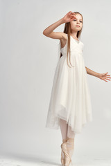 Fototapeta na wymiar 1462257 girl in white dress standing on pointes