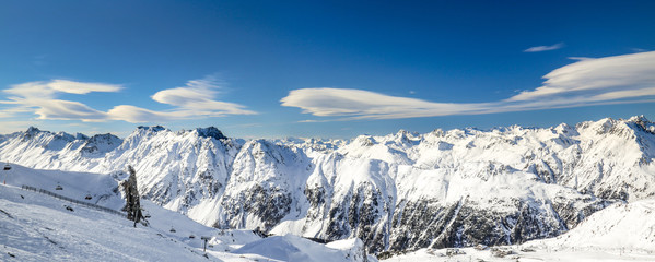 Fototapeta na wymiar Panoramic landscape of ski resort valley with amazing beatiful mountains and dramatic cloudy sky on the background in Austria, Tyrol
