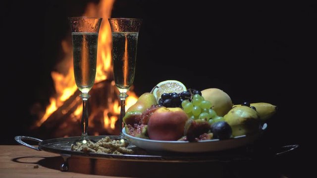 still life with champagne on the background of fire