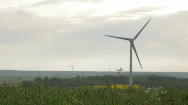 few wind turbines isolated on overcast sky background