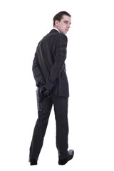 Handsome young man holding gun. Isolated on white background.