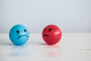 Emotions balls: Anger red ball and sad depressed blue ball