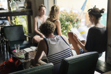 Group of caucasian people sitting relaxing in the hostel lobby