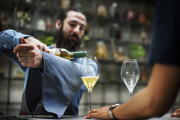 Bartender pouring a wine to the glass