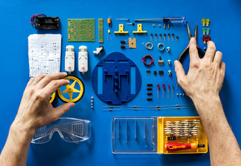 Aerial view of electronics tools equipments on blue background