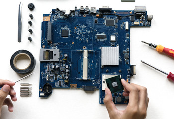Aerial view of hands with computer electronics parts on white background