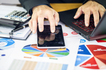 Businessman are finger touch screen the stock trading bar of a mobile phone and dialing numbers on...