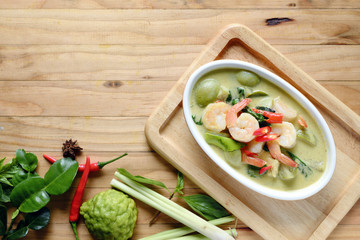 Thai food Shrimp green curry with green curry on  Pine wood background, copy space