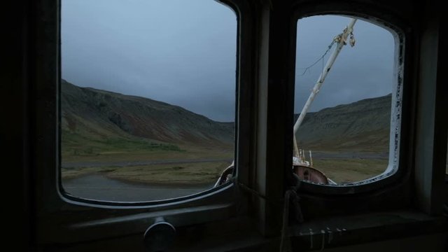 BA 64 on a beach with a dramatic sky in Patrekfjordur at the Westfjords is the oldest steelship in Iceland