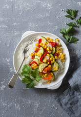 Vegetarian vegetable fajitas rice bowl on the gray table, top view. Healthy diet food concept