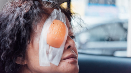 Patient asian women show her eyes with eye shield