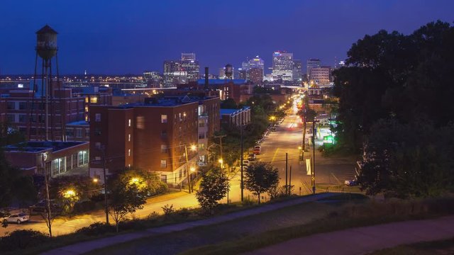 Richmond VA Cityscape Timelapse View at Dawn with Car Lights and Traffic Down Main Street featuring Historical Factory Water Towers and Tall Skyscrapers in the Virginia State Capital