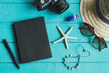 Overhead view of Traveler's accessories and items with notebook