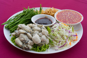 Fresh oysters in Thai style with chili paste, seafood sauce, and deep fried red onion