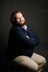 man with beard and long hair arms crossed