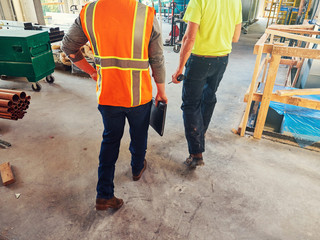 men in construction outfits walking at site