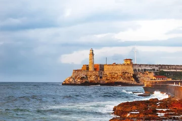 Gordijnen Fortress and lighthouse of El Morro in the entrance of Havana bay, Cuba. Sunset after storm. © Konstantin Aksenov
