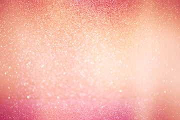 abstract defocused lights, sparkling holiday bokeh background with pink golden tones, elegant...