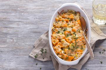 Pumpkin Gratin with leek, thyme and cheese on a gray background, selective focus