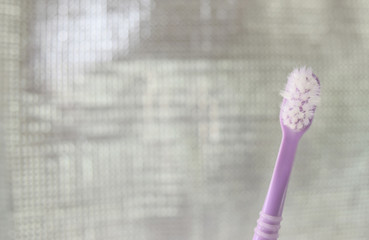 Old purple toothbrush paste prominent. On a silver glitter background.