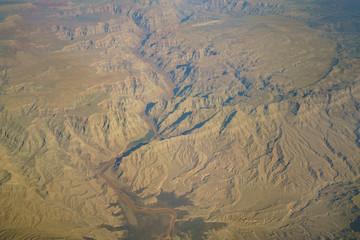 Aerial view of mountain landscape, view from window seat in an airplane