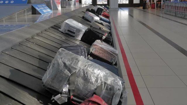 Suitcases on the baggage conveyor belt at the airport.