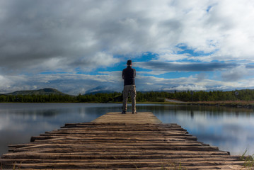 Self-portrait of hiker on a pier on a Norwegian lake