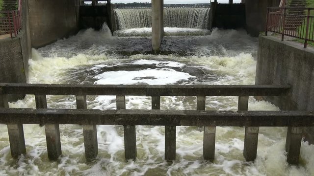 Old river dam water splash overflow after autumn rains