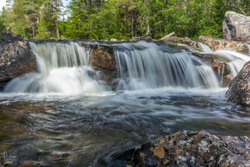A waterfall in a wild forest in a national park in Norway - 2